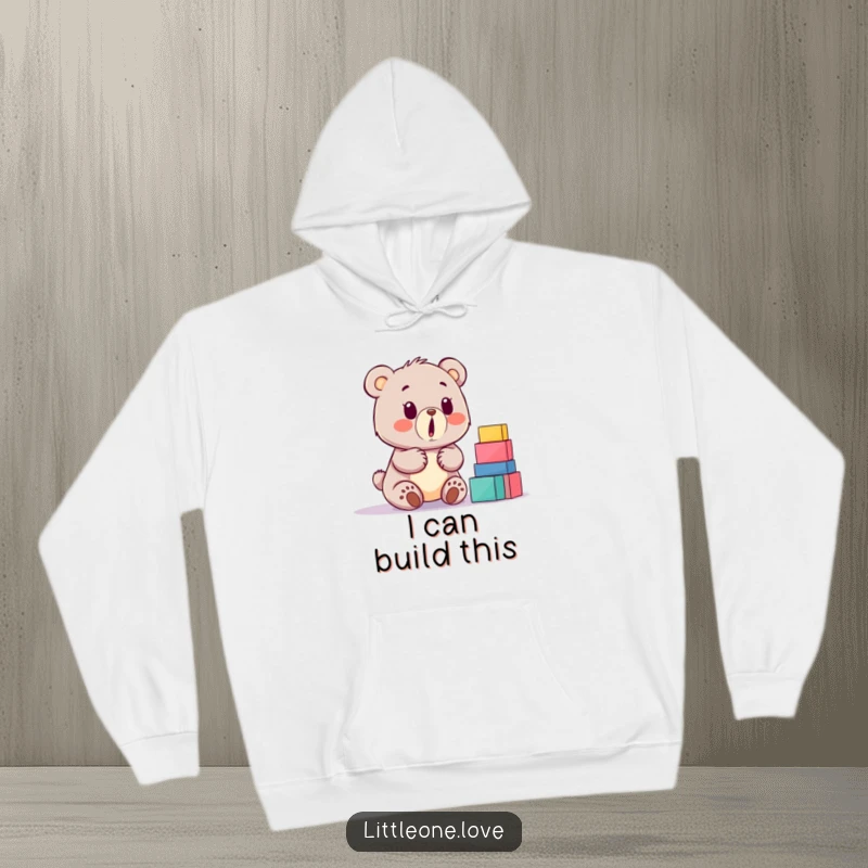 Funny baby bear hoodie, surprised by a huge stack of building blocks, cozy and humorous design for ultimate comfort.