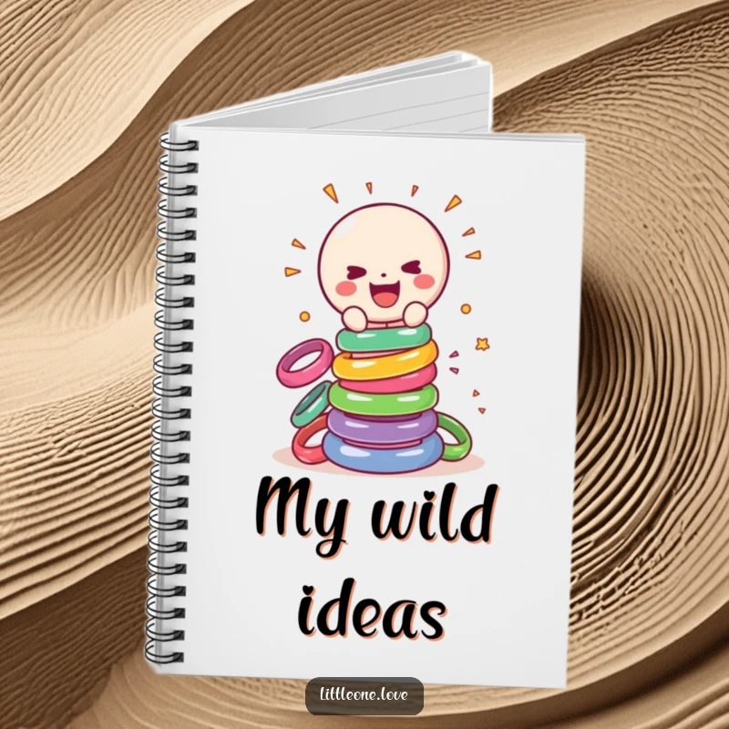 Funny notebook cover with a smiling sentient baby rattle gleefully smashing a tower of colorful rings, ideal for notes and doodles.